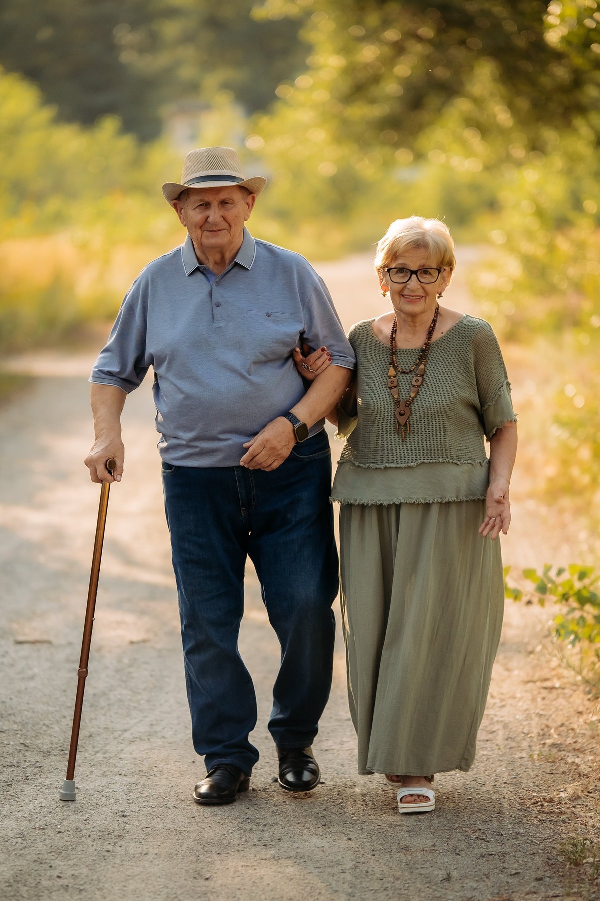 Happy elderly people walking in the park on a sunny day.