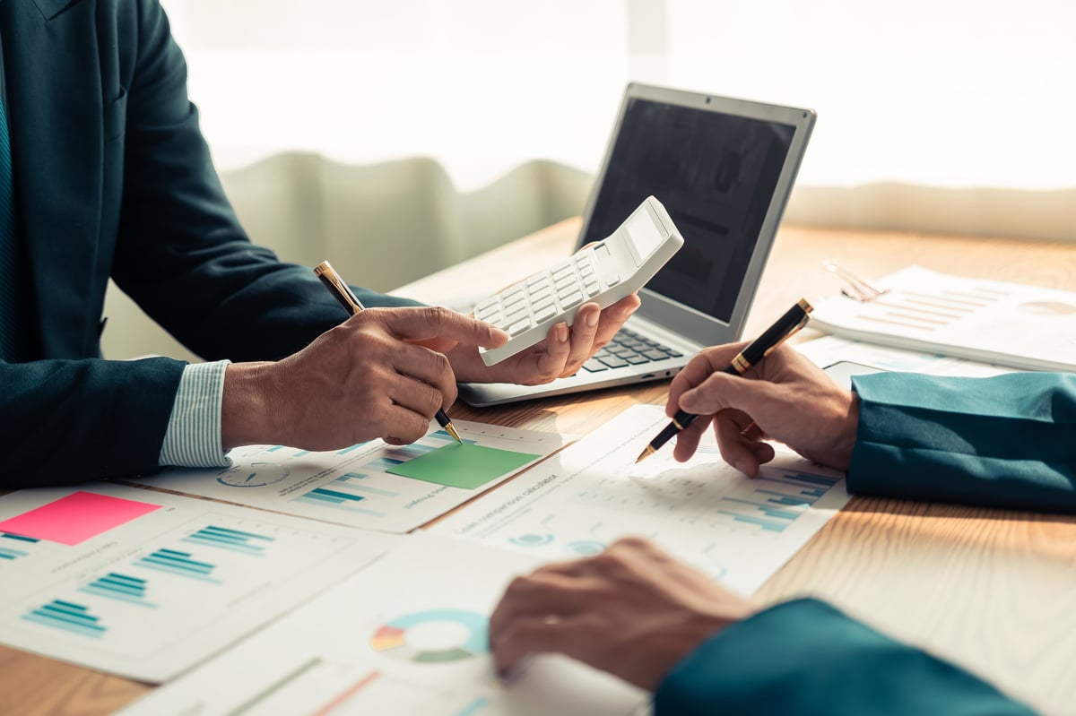Business people discussing charts and graphs showing results of teamwork in a meeting to analyze financial reports, planning strategies, success.